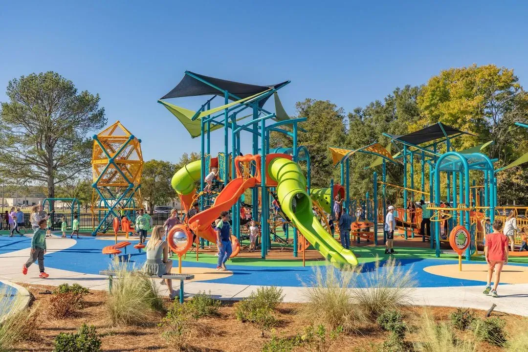 Children playing on a teal and lime playground
